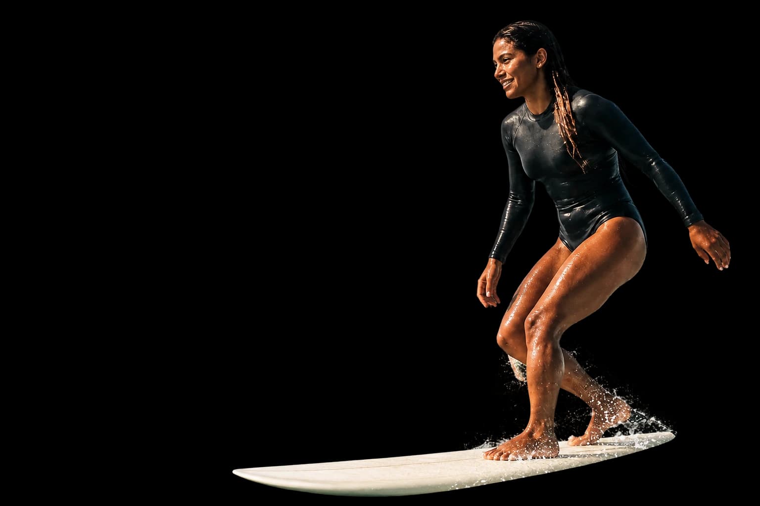A longboard surfer riding a sunlit ocean wave